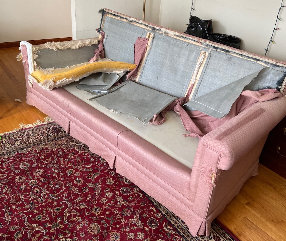 pink sofa with upholstery partially removed