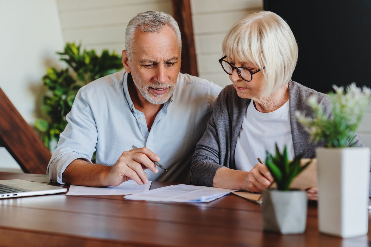 Couple reviewing mortgage numbers to determine home affordability with $160,000 household income in Southwest Florida.