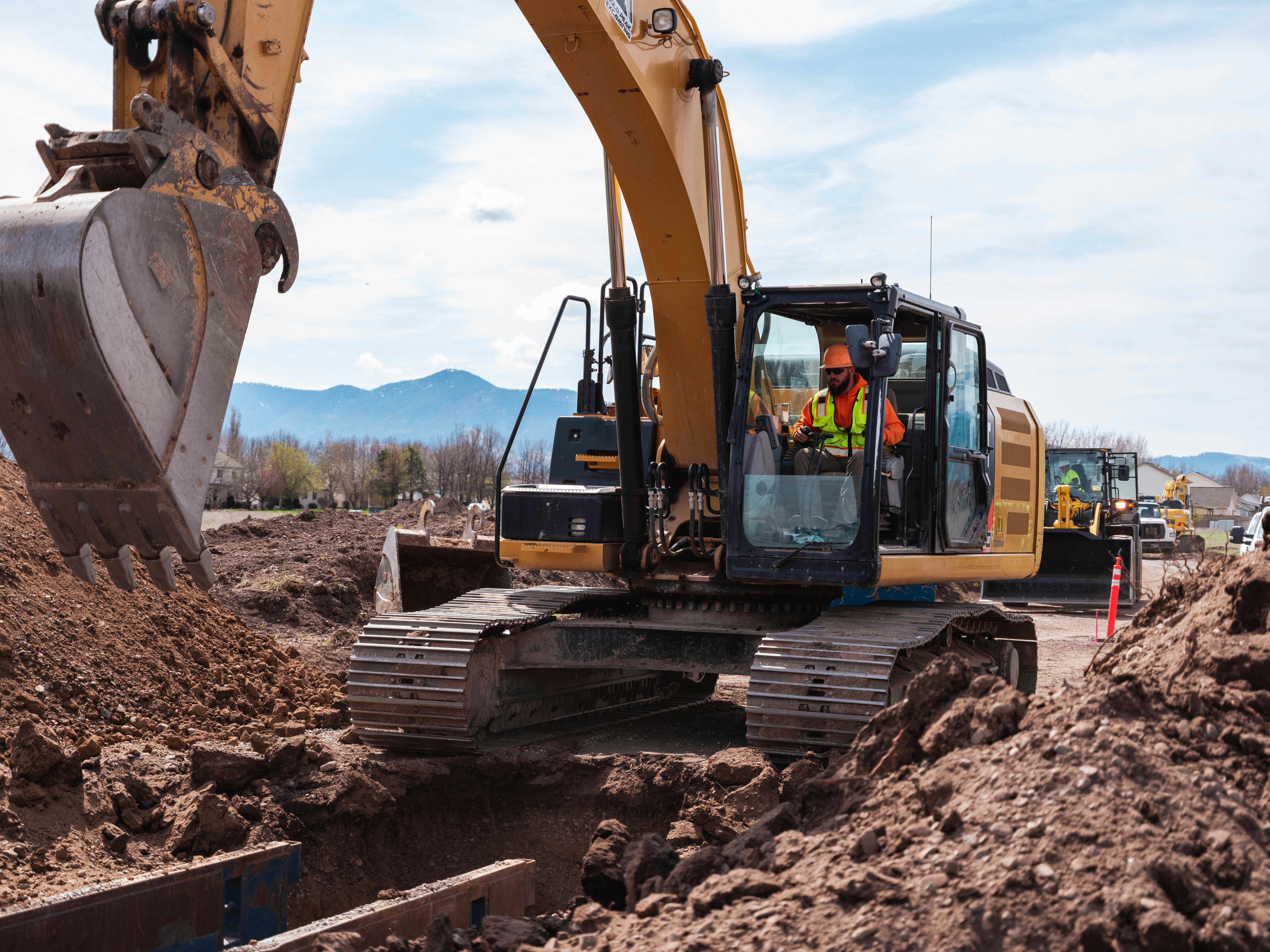 Grading equipment working on commercial construction site