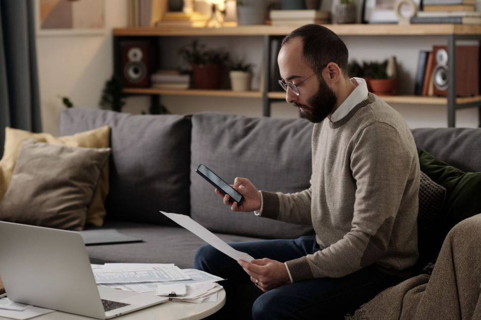 Homeowner in Stafford County VA reviewing his 2026 property tax assessment in a modern living room