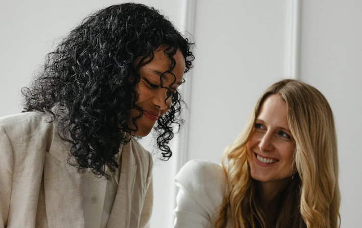 Women smiling and working together