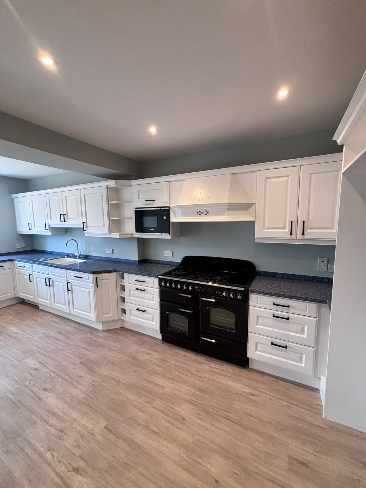White kitchen after professional cabinet respraying in Jersey
