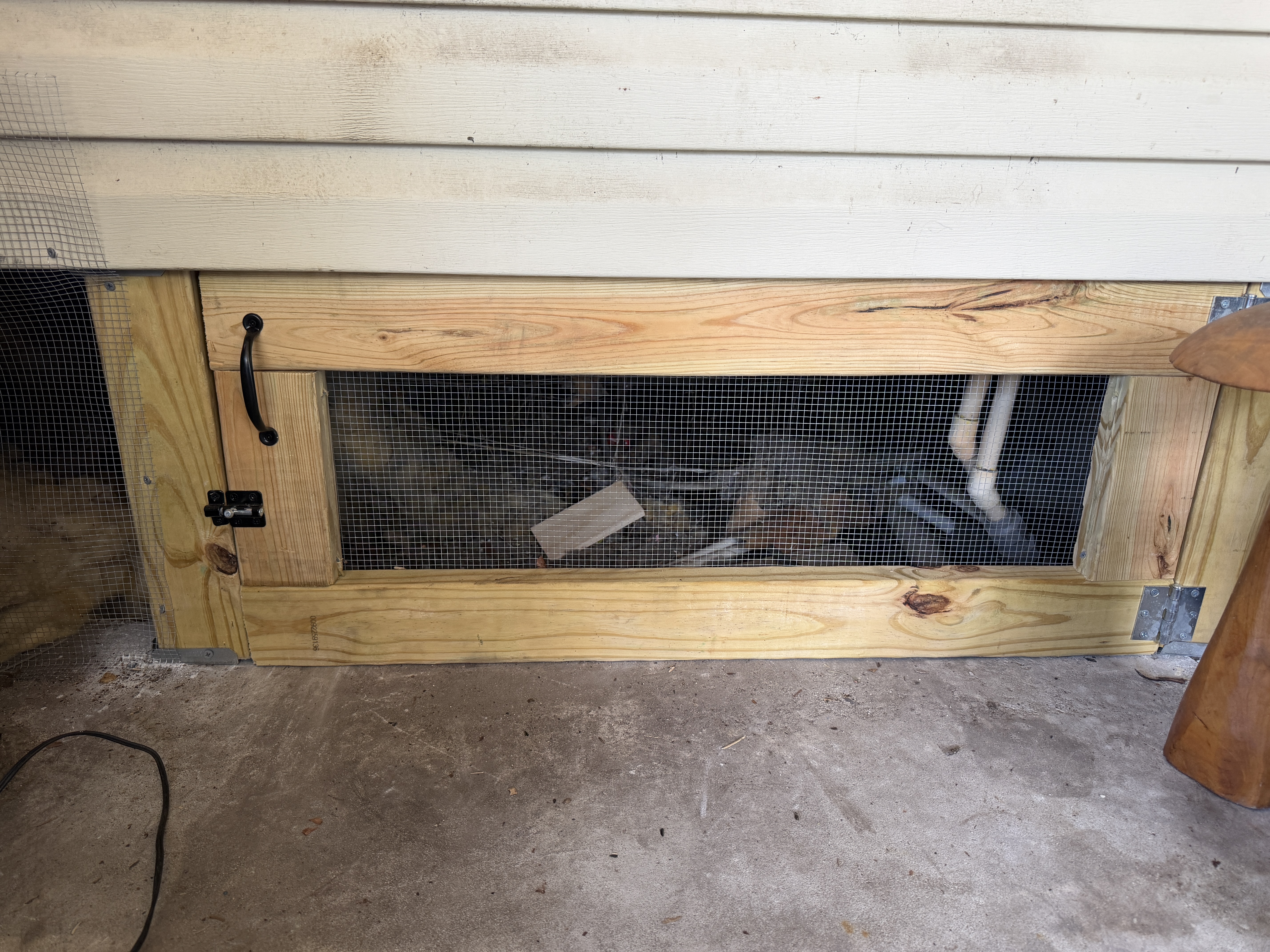 Custom-built crawlspace access door on a mobile home skirting job