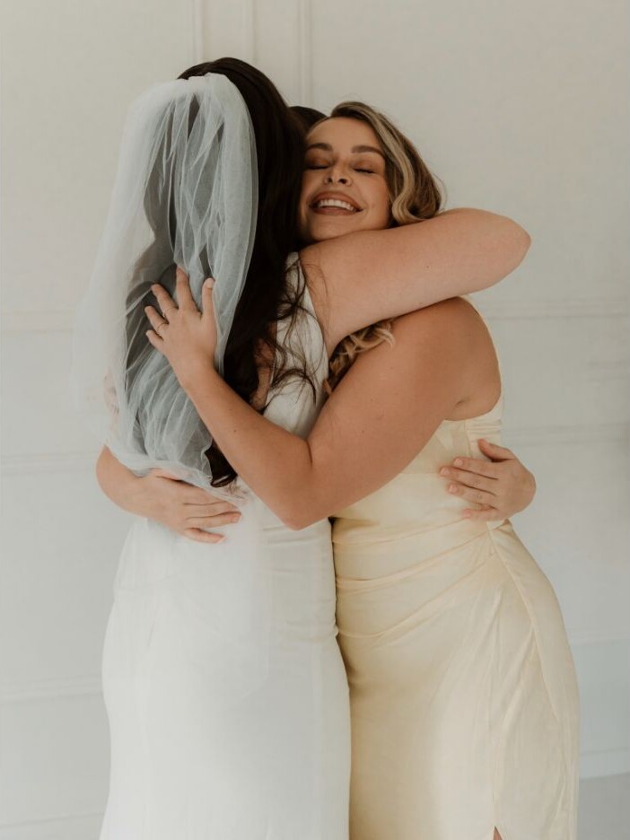 Bride sharing an emotional embrace on her wedding day