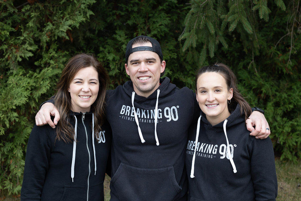 Breaking Ninety coaches in their team hoodies
