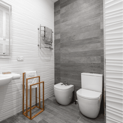 Compact bathroom renovation featuring sleek fixtures and textured walls