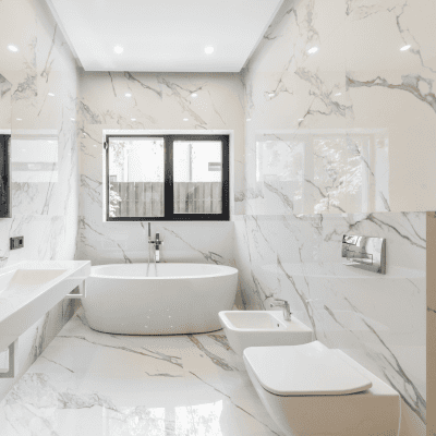 Luxurious new bathroom design with marble tiles and freestanding bathtub