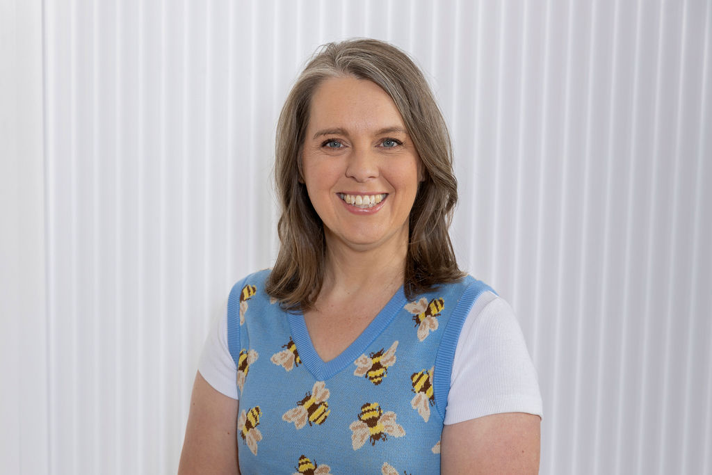 Selena Woodward, spiritual business coach, smiling at the camera