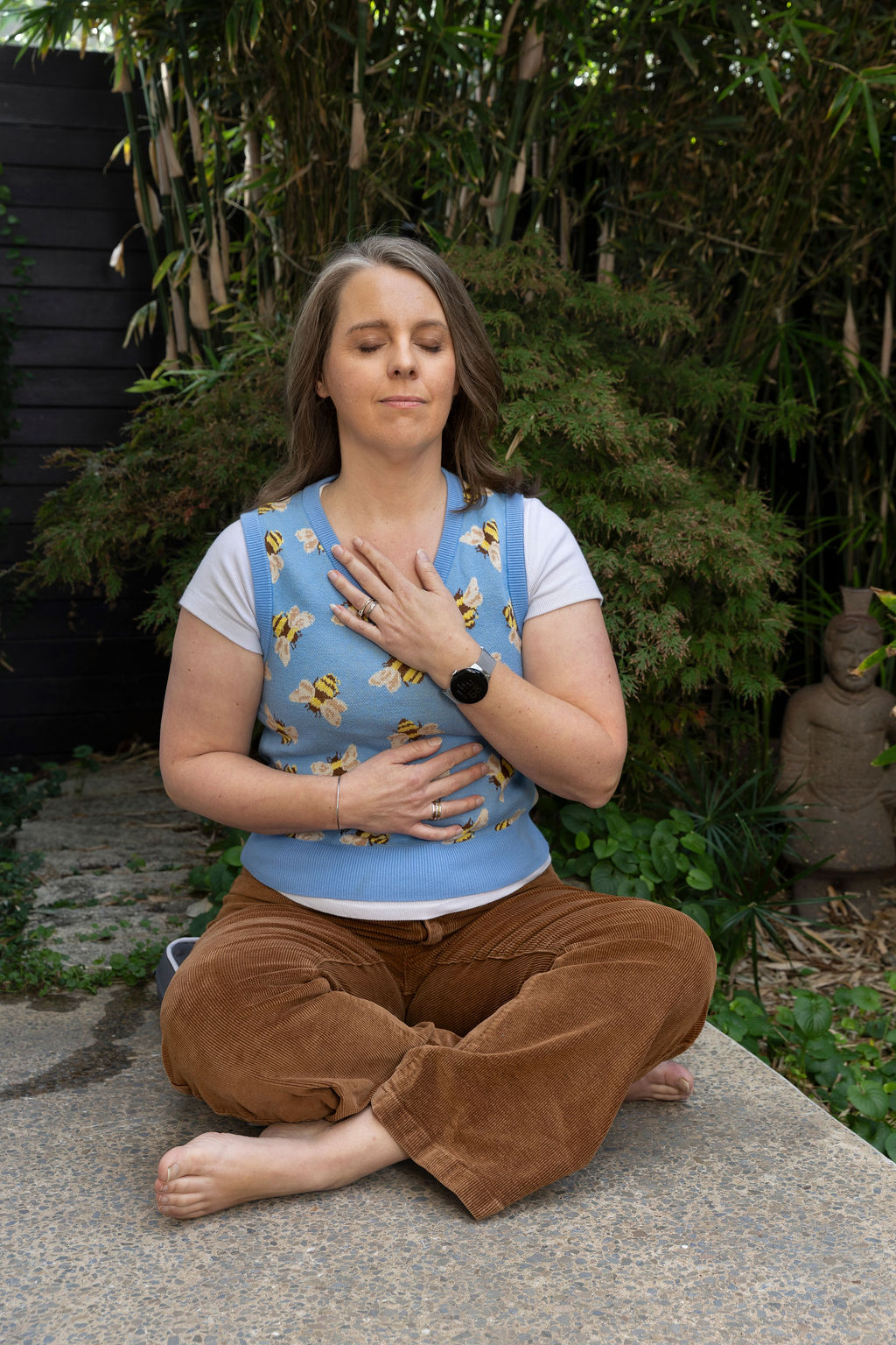 Selena Woodward in quiet meditation in a garden, Adelaide