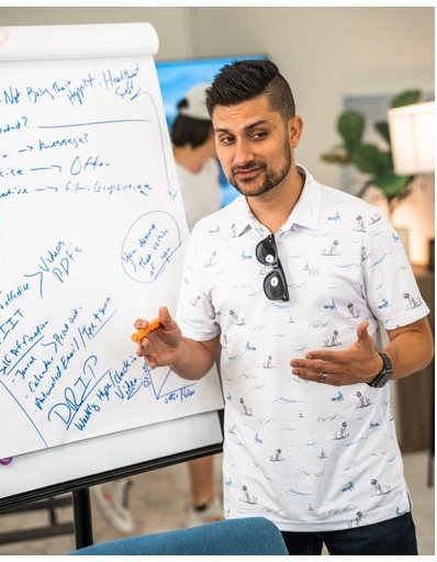 Jordan at a whiteboard, mapping out a client&rsquo;s message.