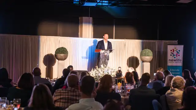 Speaking from the stage at a Men for Life event