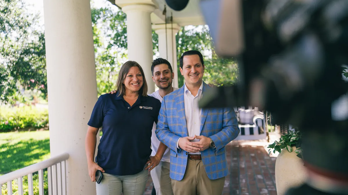 Jordan Sellers with two clients on a porch during a shoot