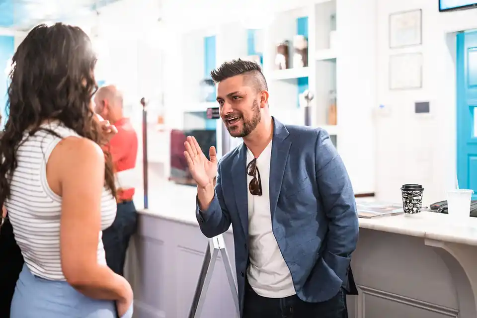 Jordan in conversation with a client at her shop counter