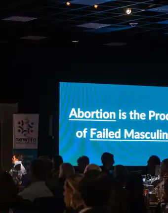 Men for Life event crowd and stage screen