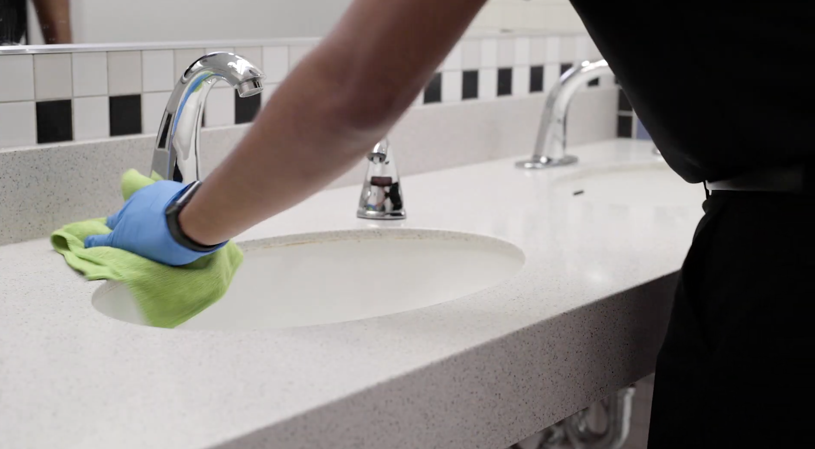 office cleaner cleaning the restroom