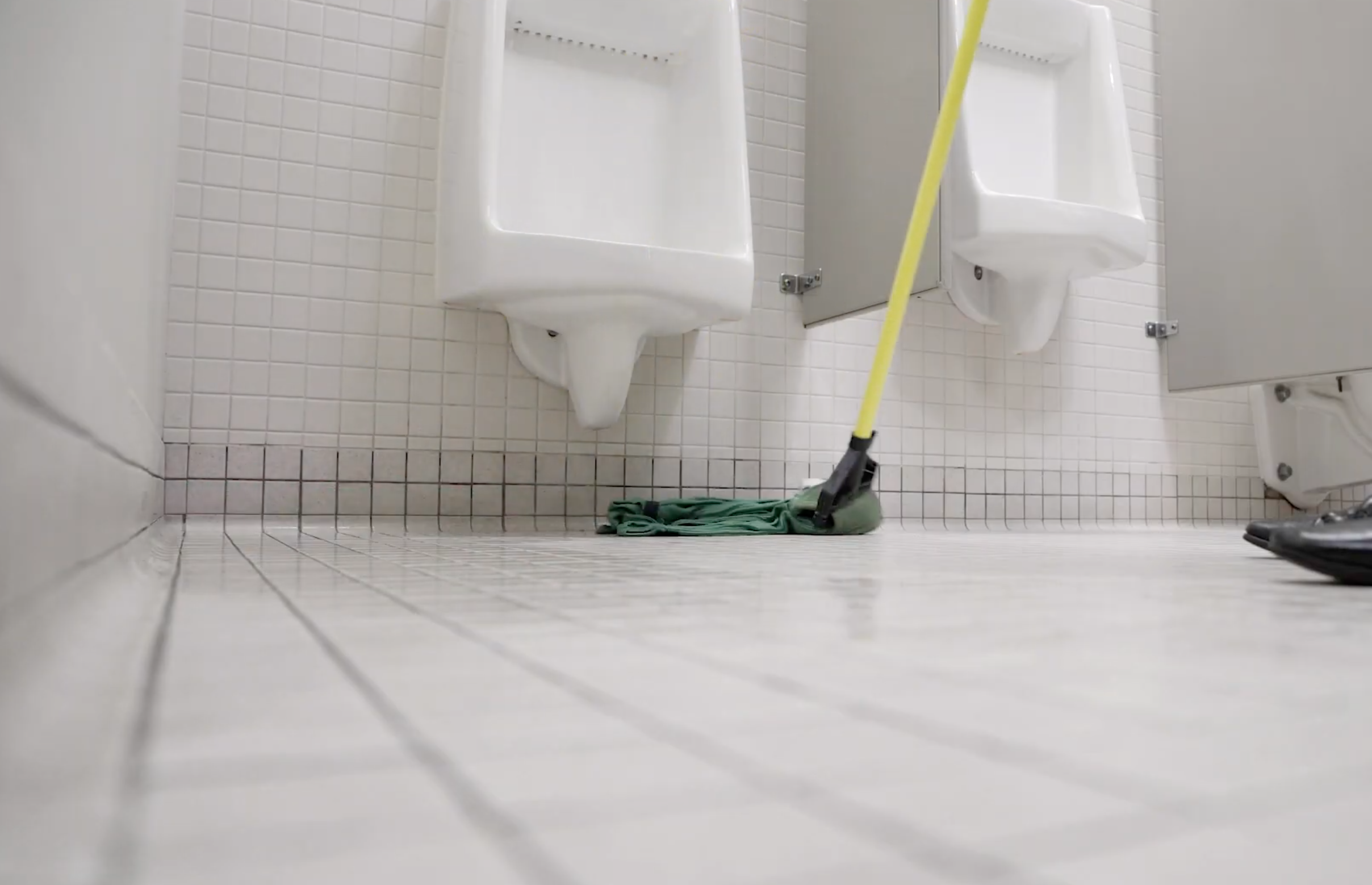 janitor mopping a tile floor