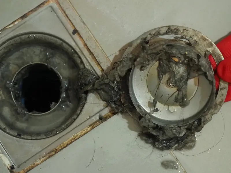Eastside Repipe plumber running cable auger for drain cleaning in a Bellevue WA home