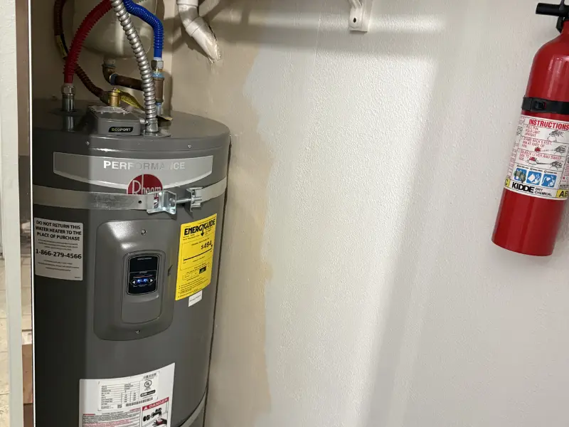 Eastside Repipe And Plumbing technician installing a tankless water heater as part of specialized plumbing services in Bellevue WA Eastside Repipe And Plumbing technician installing a tankless water heater as part of specialized plumbing services in Bellevue WA
