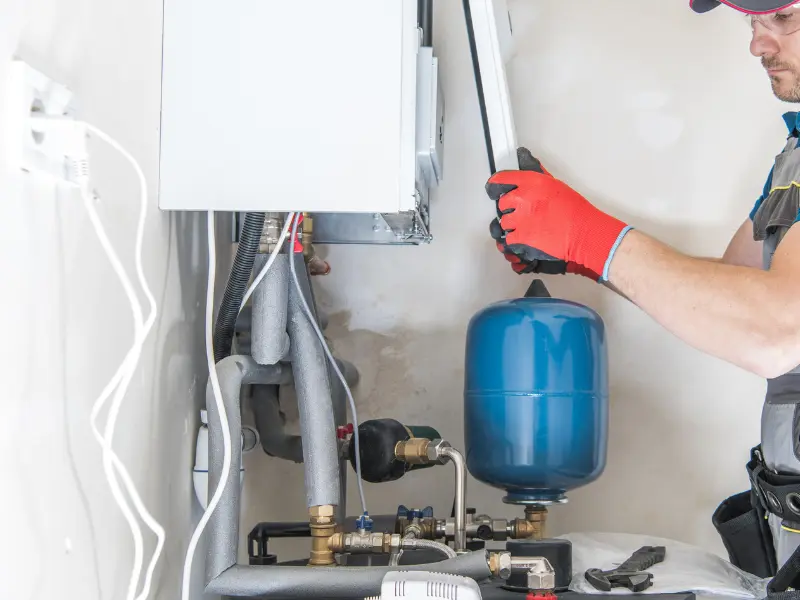 Eastside Repipe And Plumbing technician installing a whole-home water filtration system in Bellevue WA Eastside Repipe And Plumbing technician installing a whole-home water filtration system in Bellevue WA