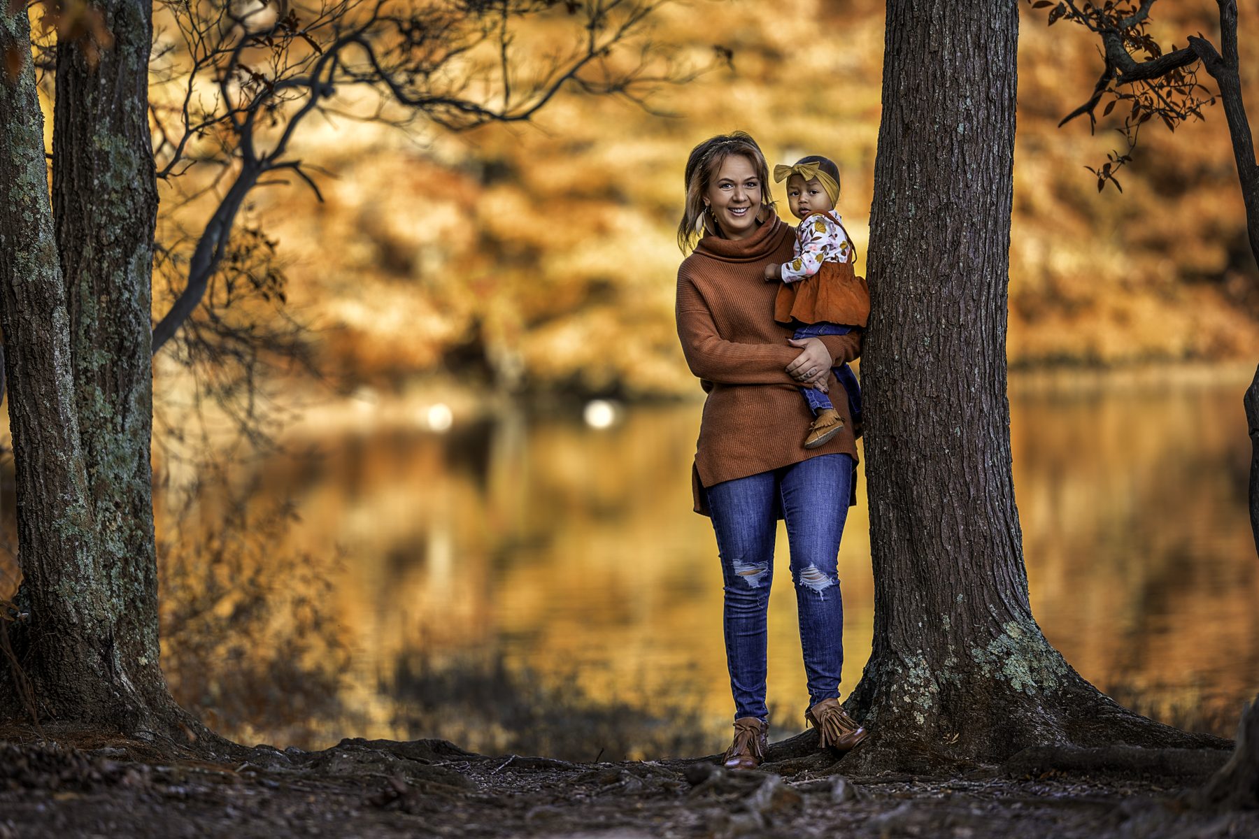 Mother and child under fall trees