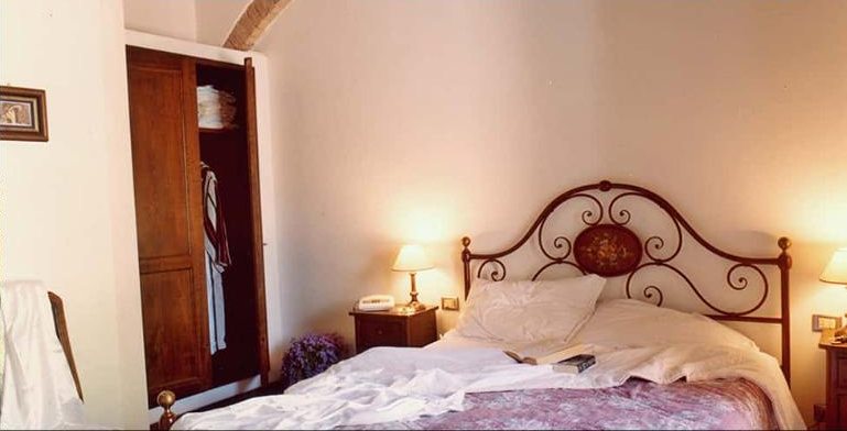 Cipresso bedroom with a wrought-iron double bed