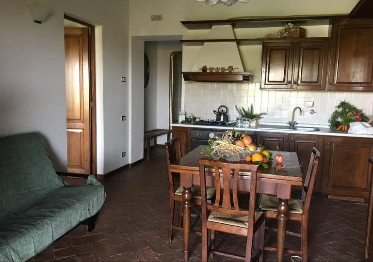 Glicine living room and kitchen with dark oak cabinets and a set dining table