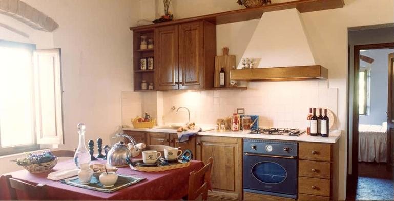 Lavanda kitchen in walnut with a blue oven and a table set for breakfast