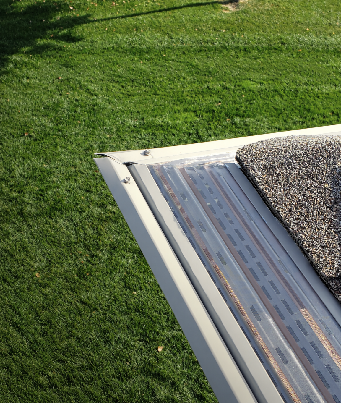 Clean MasterShield micromesh gutter protection installed along a roofline