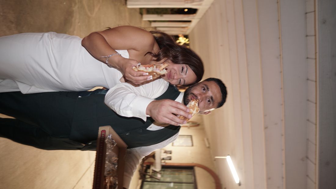 A couple sharing a bite of cake.