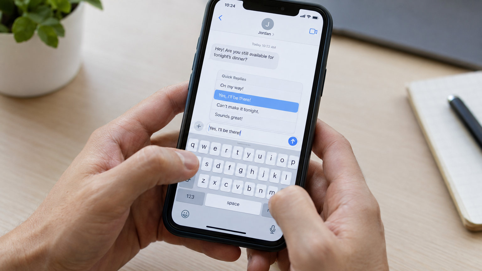 Close-up of hands above a smartphone keyboard with a pre-written reply being selected from a menu