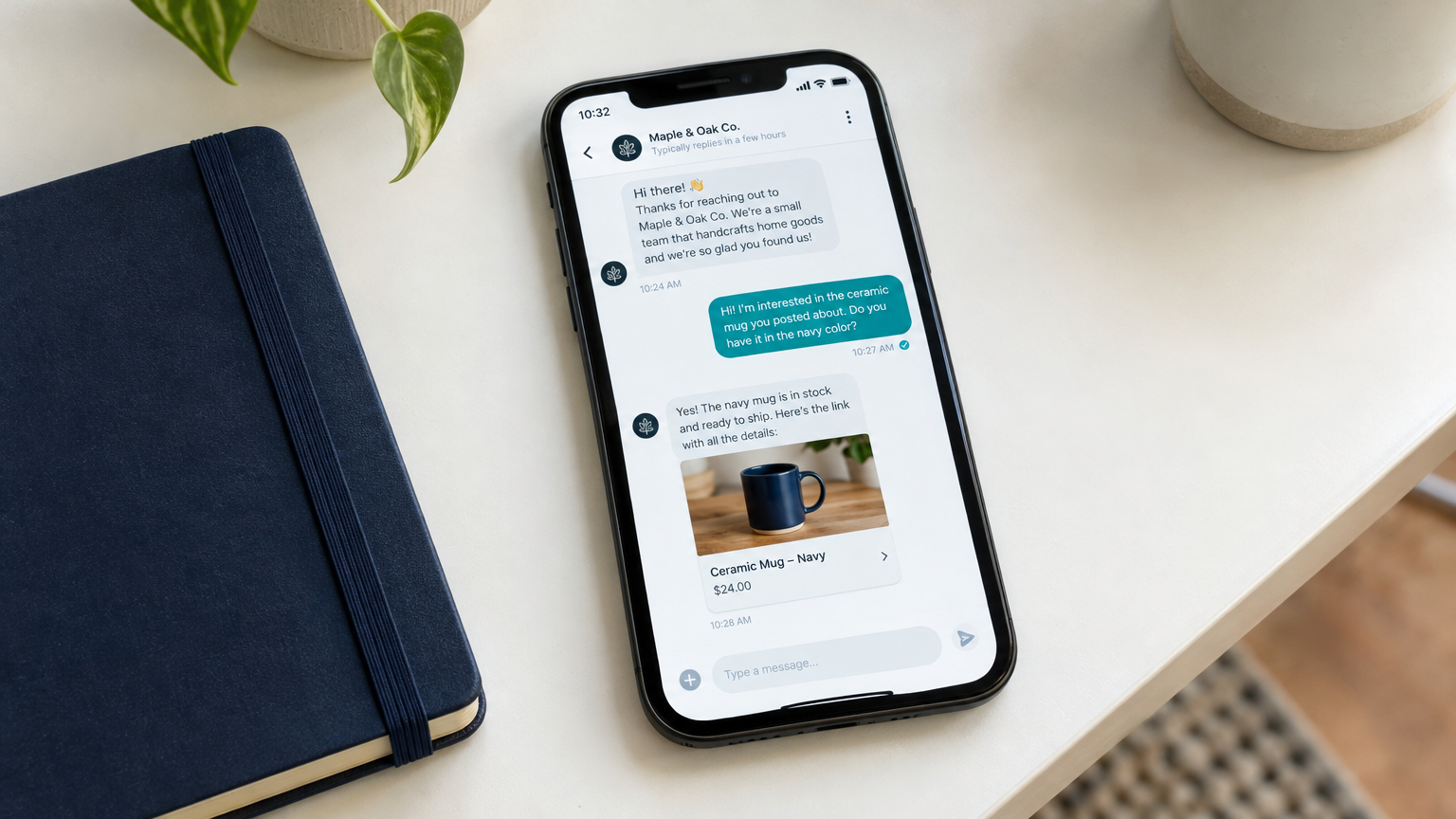 Smartphone resting on a clean white desk showing a chat conversation thread with a small business, teal notification bubble visible
