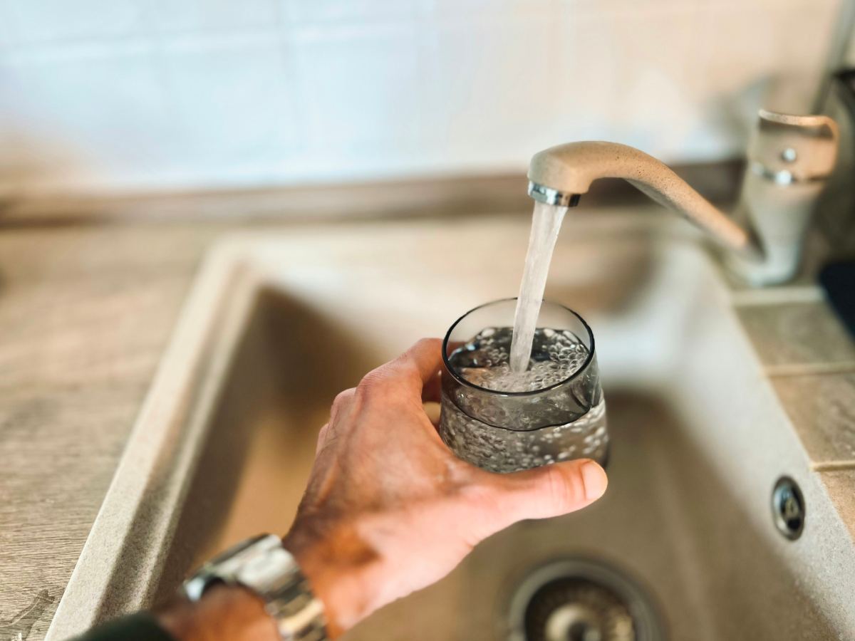 Filling a glass of water at the kitchen sink