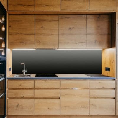 Simple modern kitchen with wooden cabinets and black accents