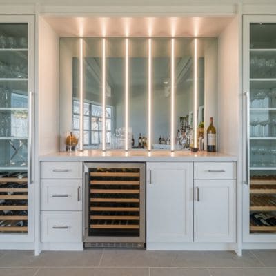 White kitchen with wine cooler and glass cabinetry