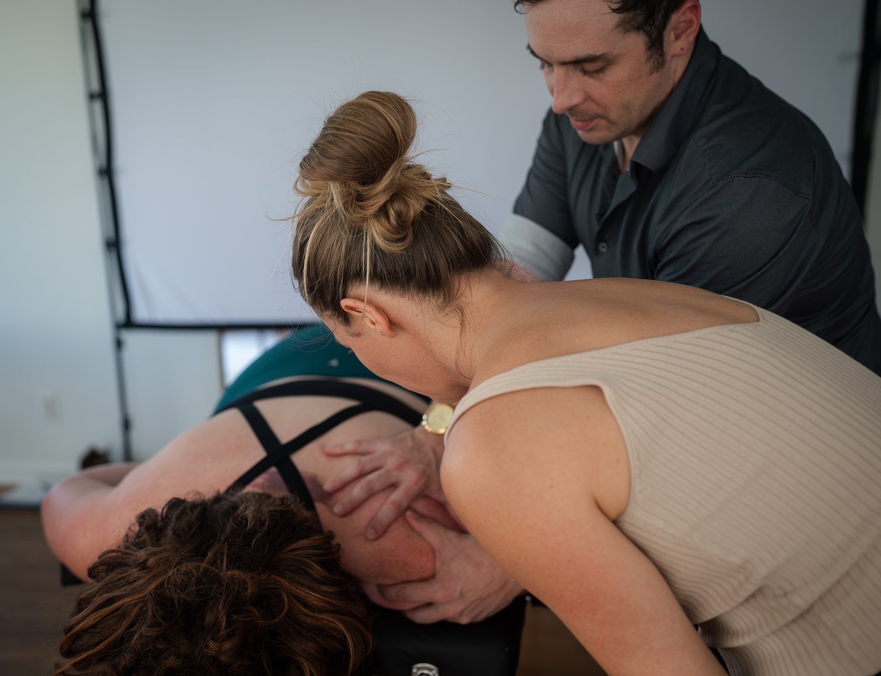 Daniel supervising a student pair during hands-on practice