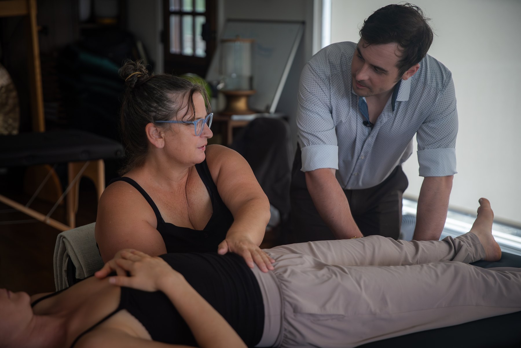 Practitioners working in pairs on the table
