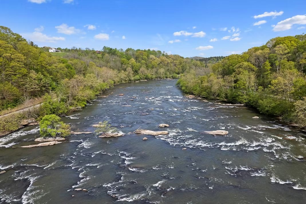 The French Broad River running past the farm
