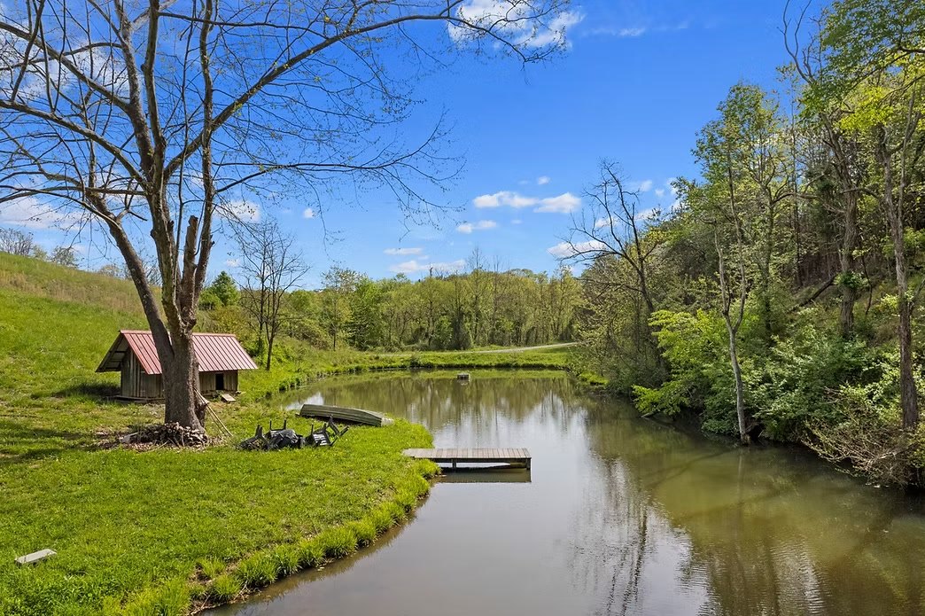Cabins and pond at French Broad River Farms — on-site lodging