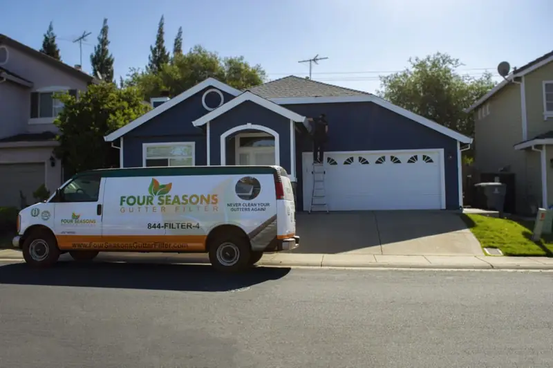 Four Seasons Gutter Filter service van outside a home