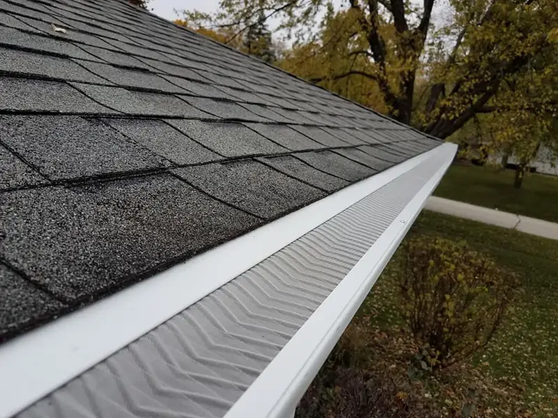 Micro-mesh gutter guard installed on a white gutter