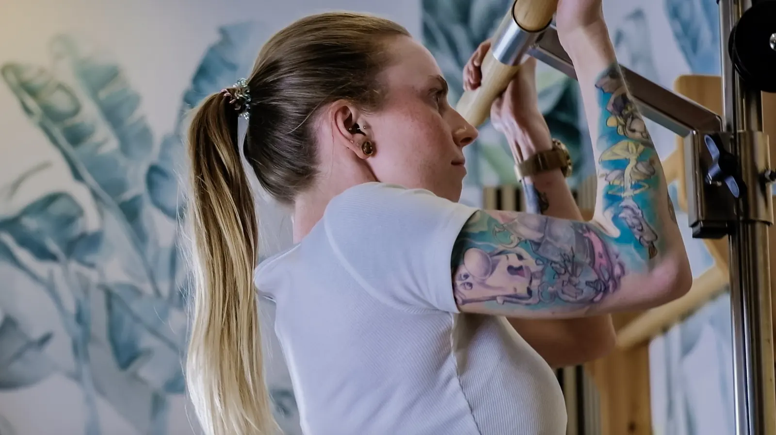 A woman training on her own at the wall bars in the Open Gym
