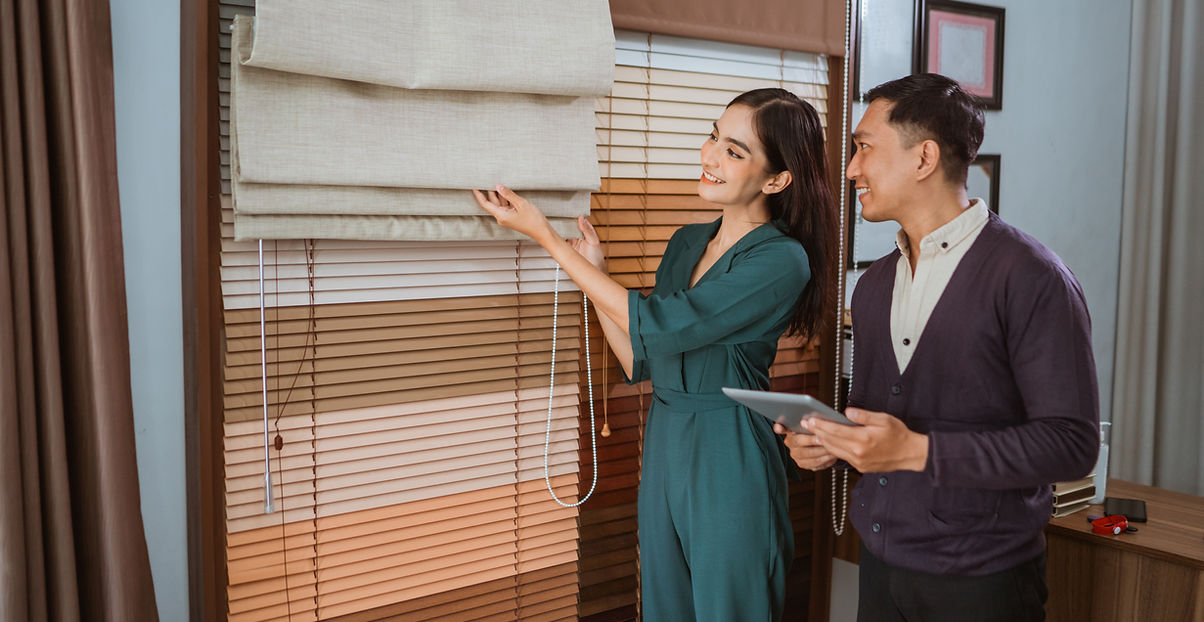 Woman presenting curtains to a man
