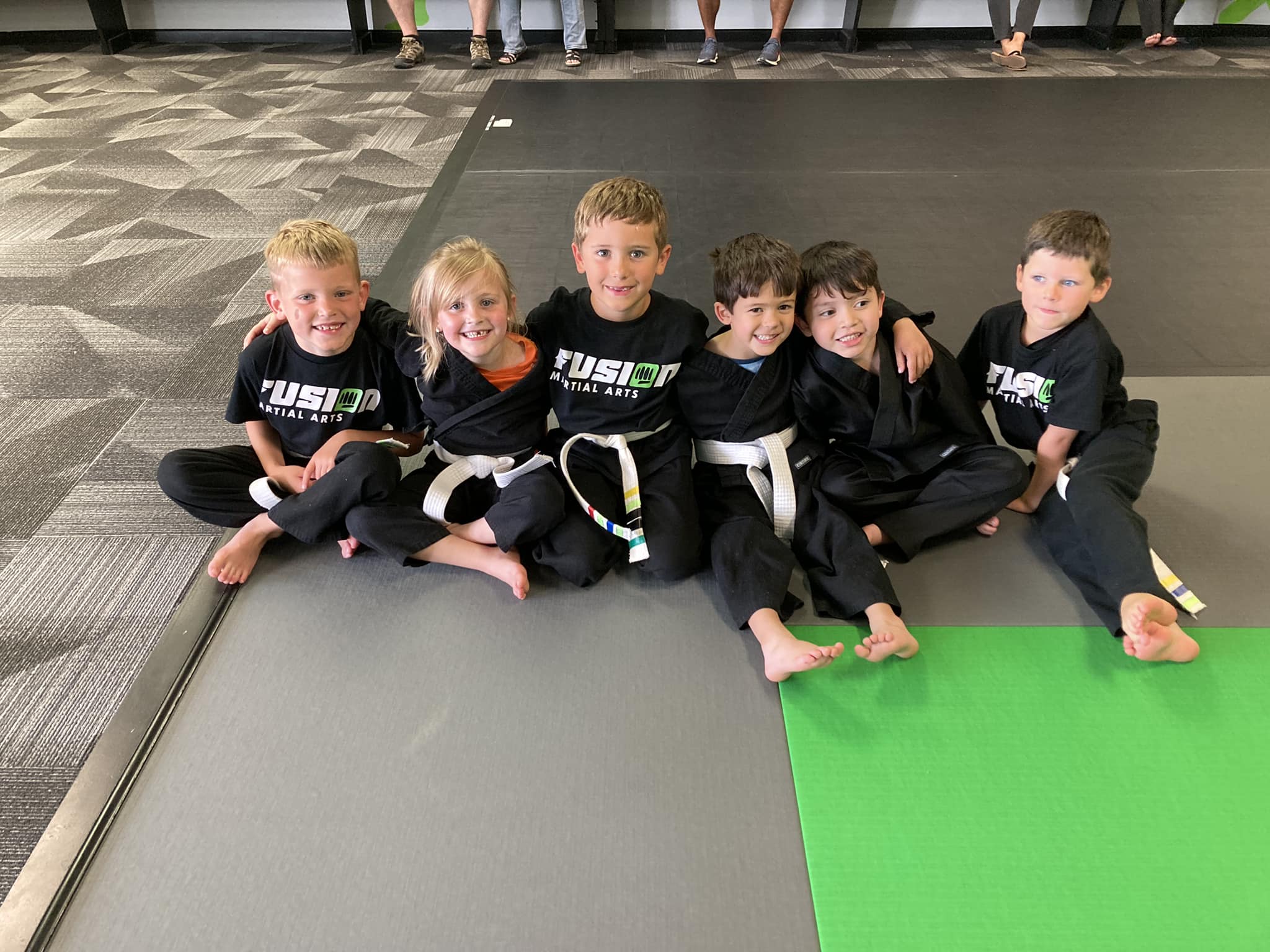 Group of kids together on the mats at Fusion Martial Arts in Bloomington