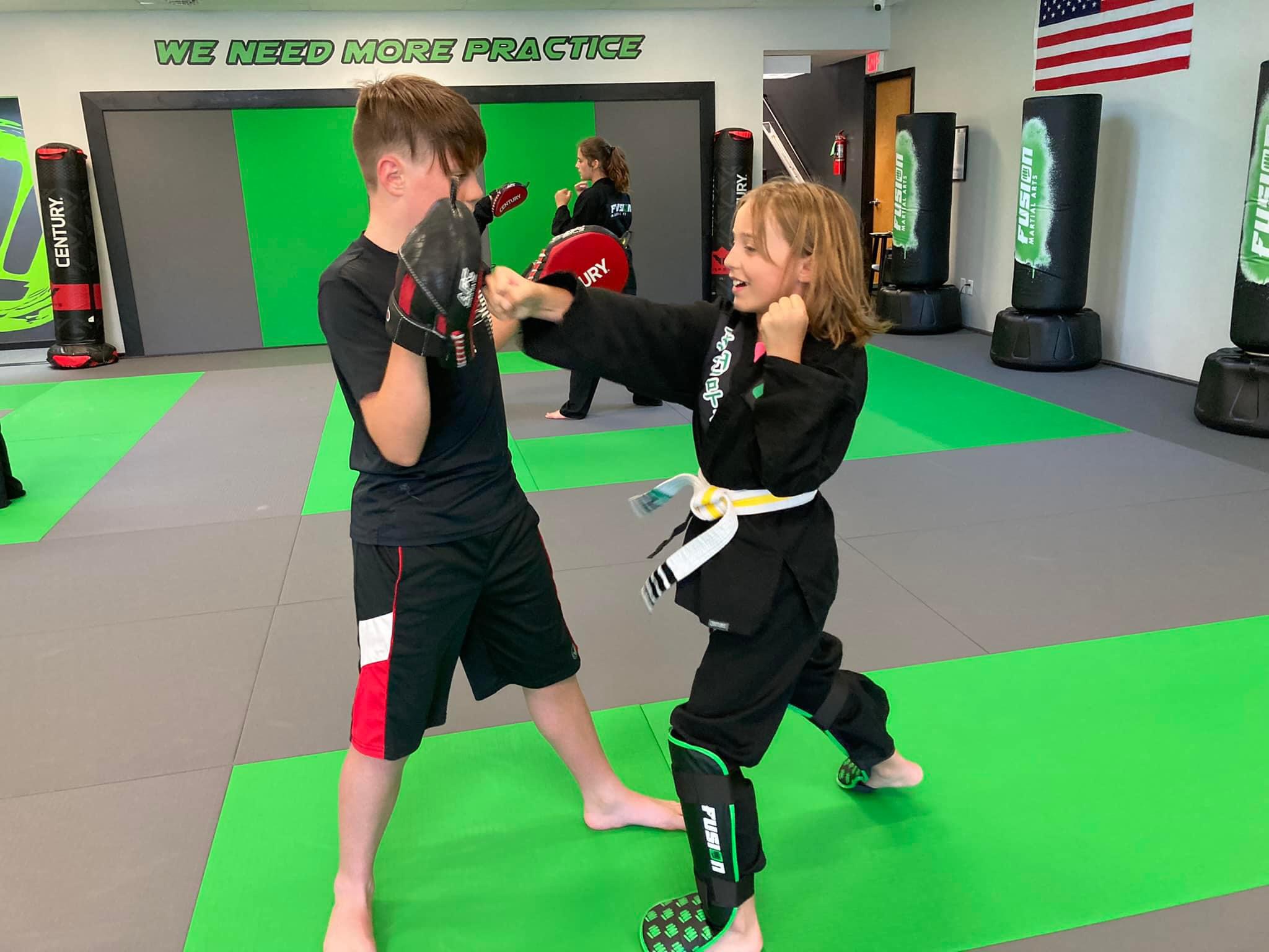 Kids pad work training at Fusion Martial Arts