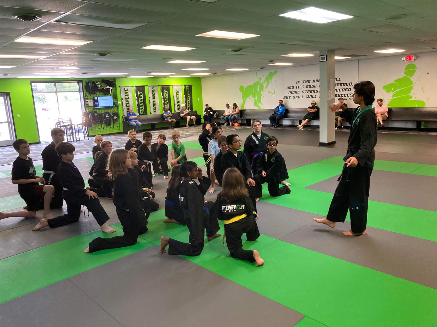 Kids listening to their instructor at Fusion