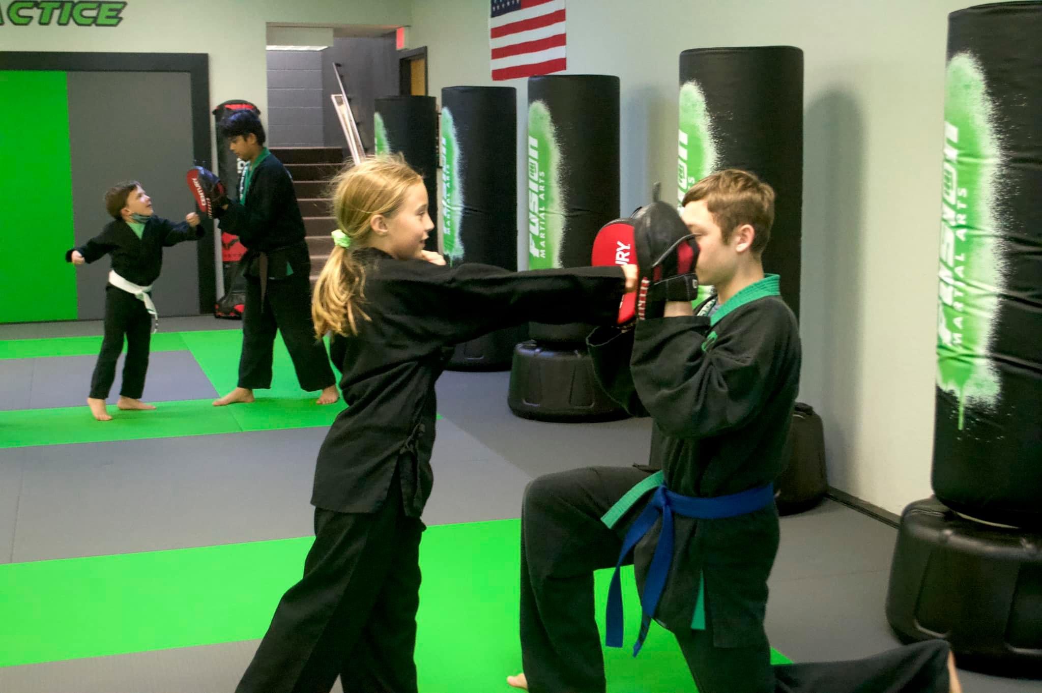 Kids pad work training at Fusion Martial Arts in Bloomington