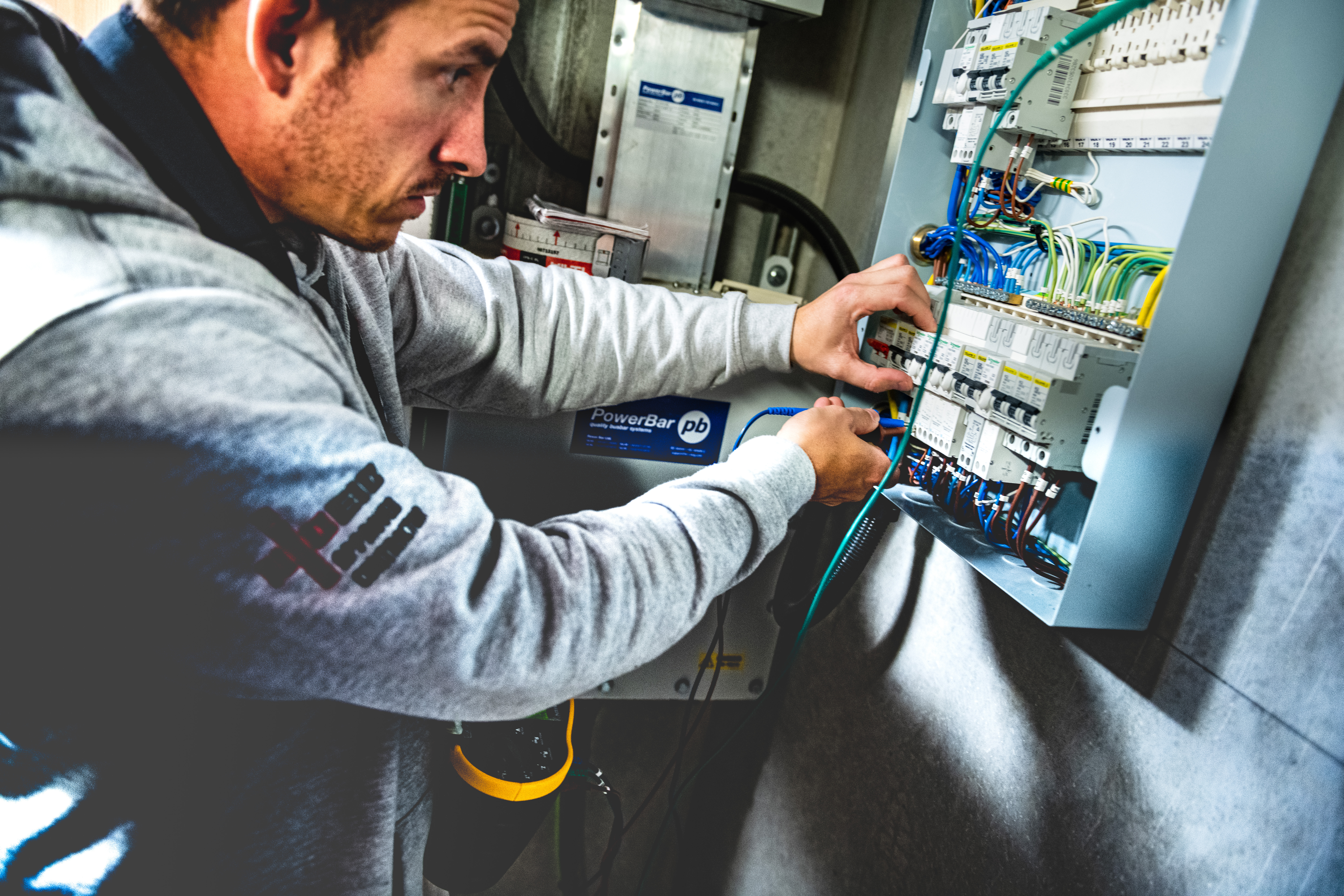 NICEIC approved electrician testing a consumer unit with a multifunction installation tester for an EICR report