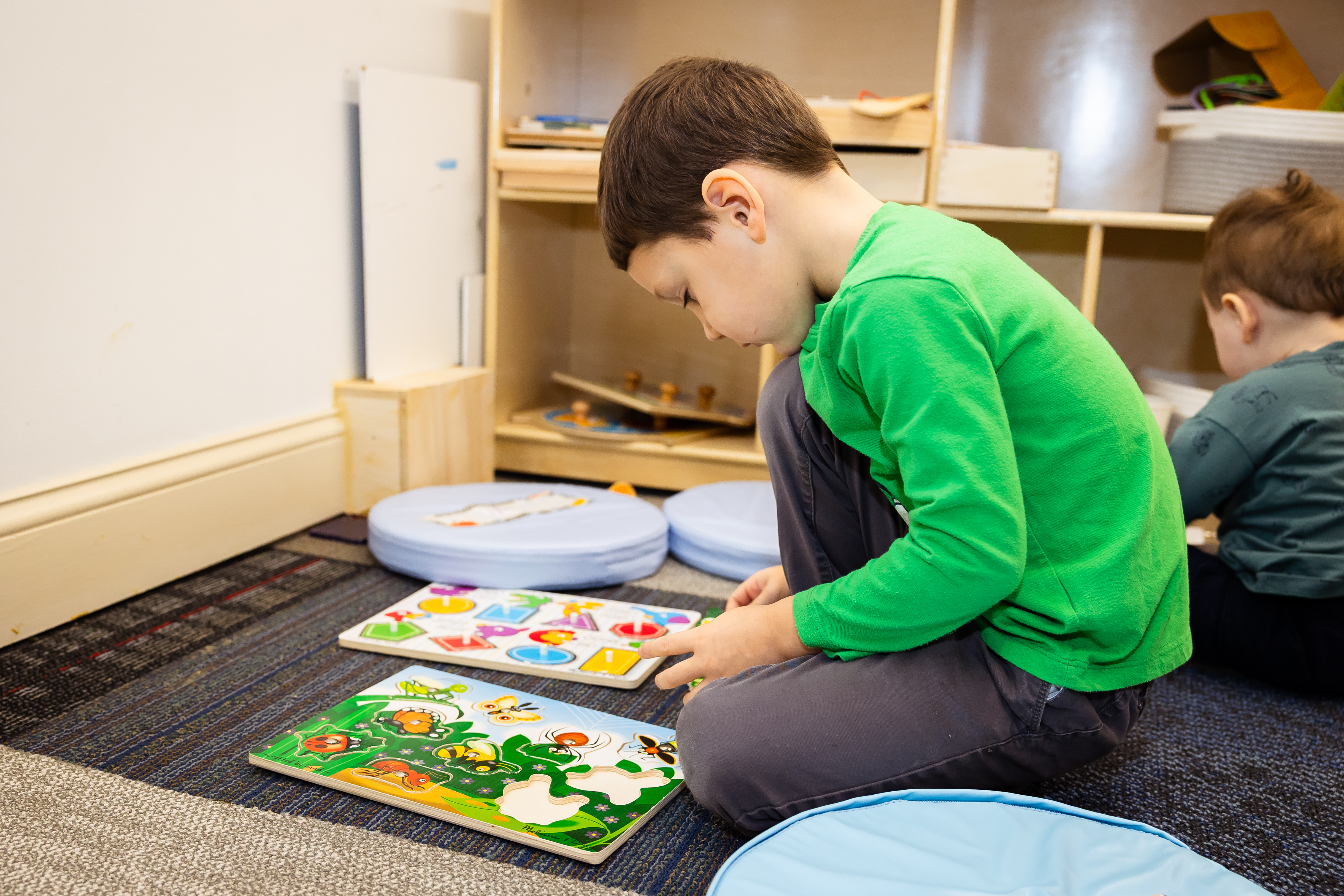 Child solving puzzle independently at Apogee CT, practicing focus and resilience.