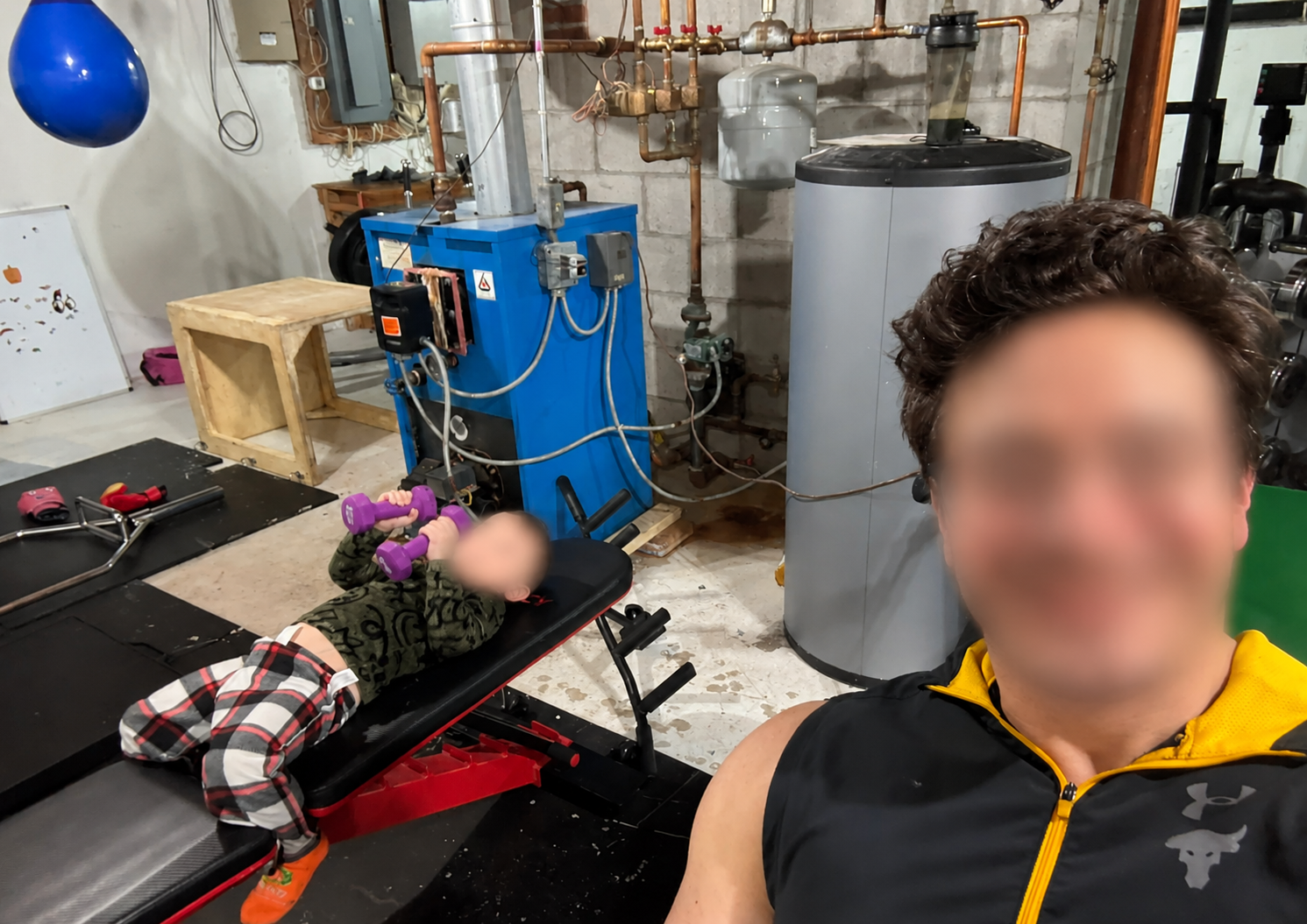 Dad and son working out together in a home gym, demonstrating the importance of exercise, healthy lifestyles, and positive role modeling for children.