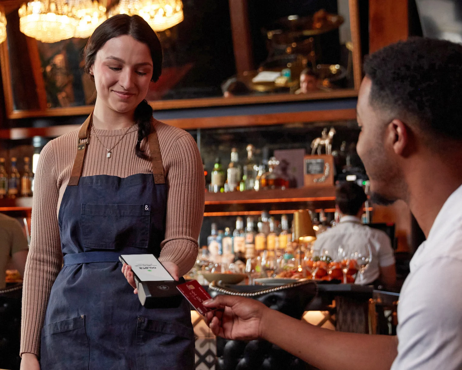 Genius POS tableside handheld terminal in a Utah restaurant — increase ticket volume up to 15% with tableside ordering, eliminating the bottlenecks caused by Toast, Square and Clover proprietary systems